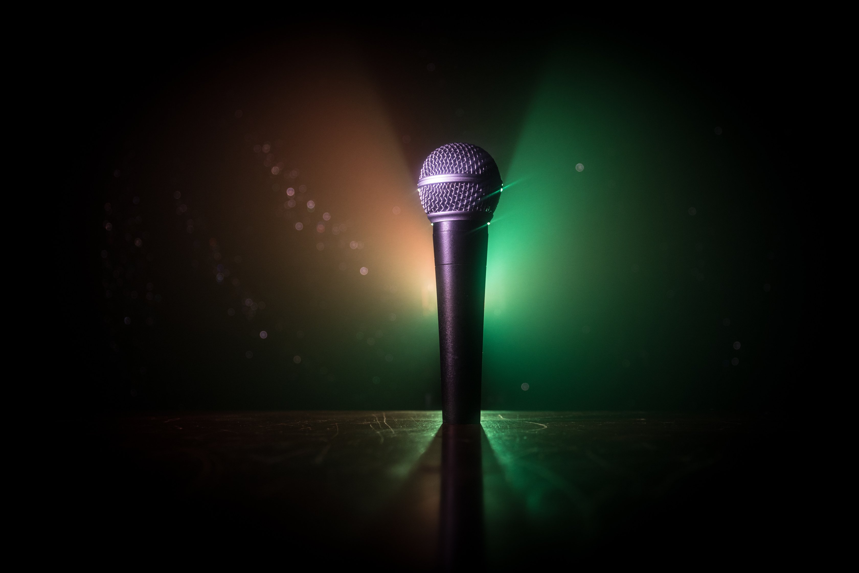 Microphone karaoke, concert . Vocal audio mic in low light with blurred background. Live music, audio equipment. Karaoke concert, sing sound. Singer in karaokes, microphones.